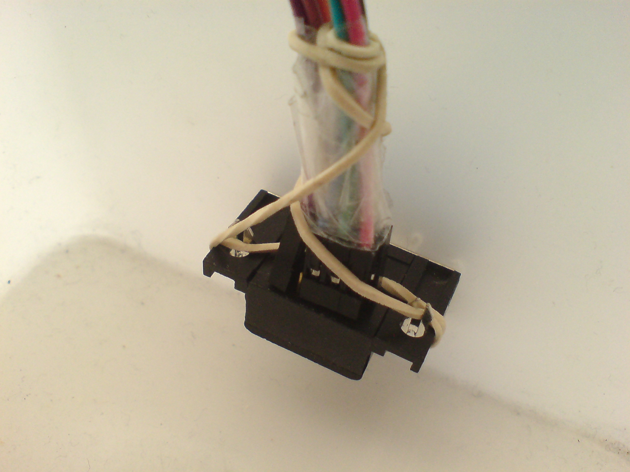 Use tape and rubber band to hold wires in socket